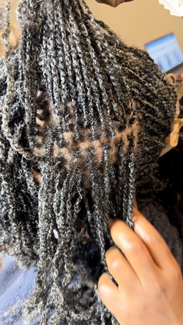 Separating mature, grayed locs during a retightening